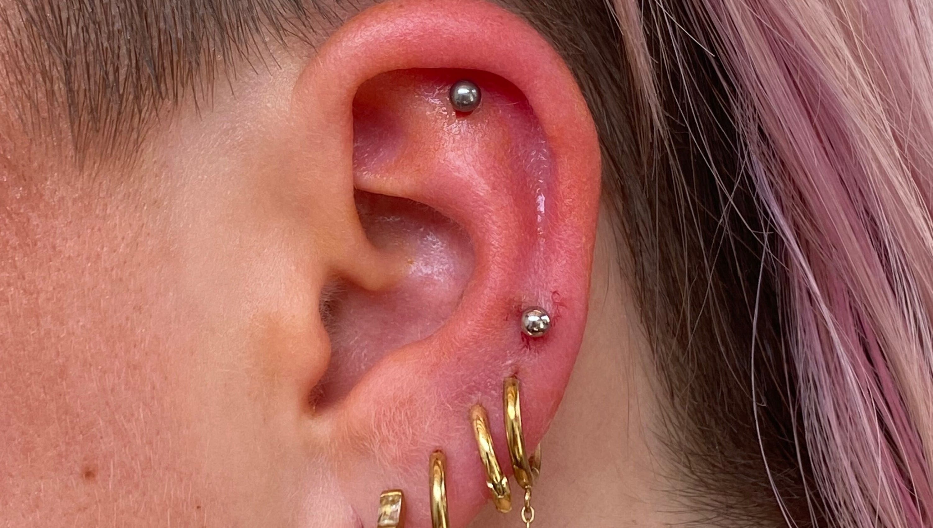 Piercing élégant à l'oreille chez Vices Underskin, Lille, Hauts-de-France, FR, bijoux dorés.