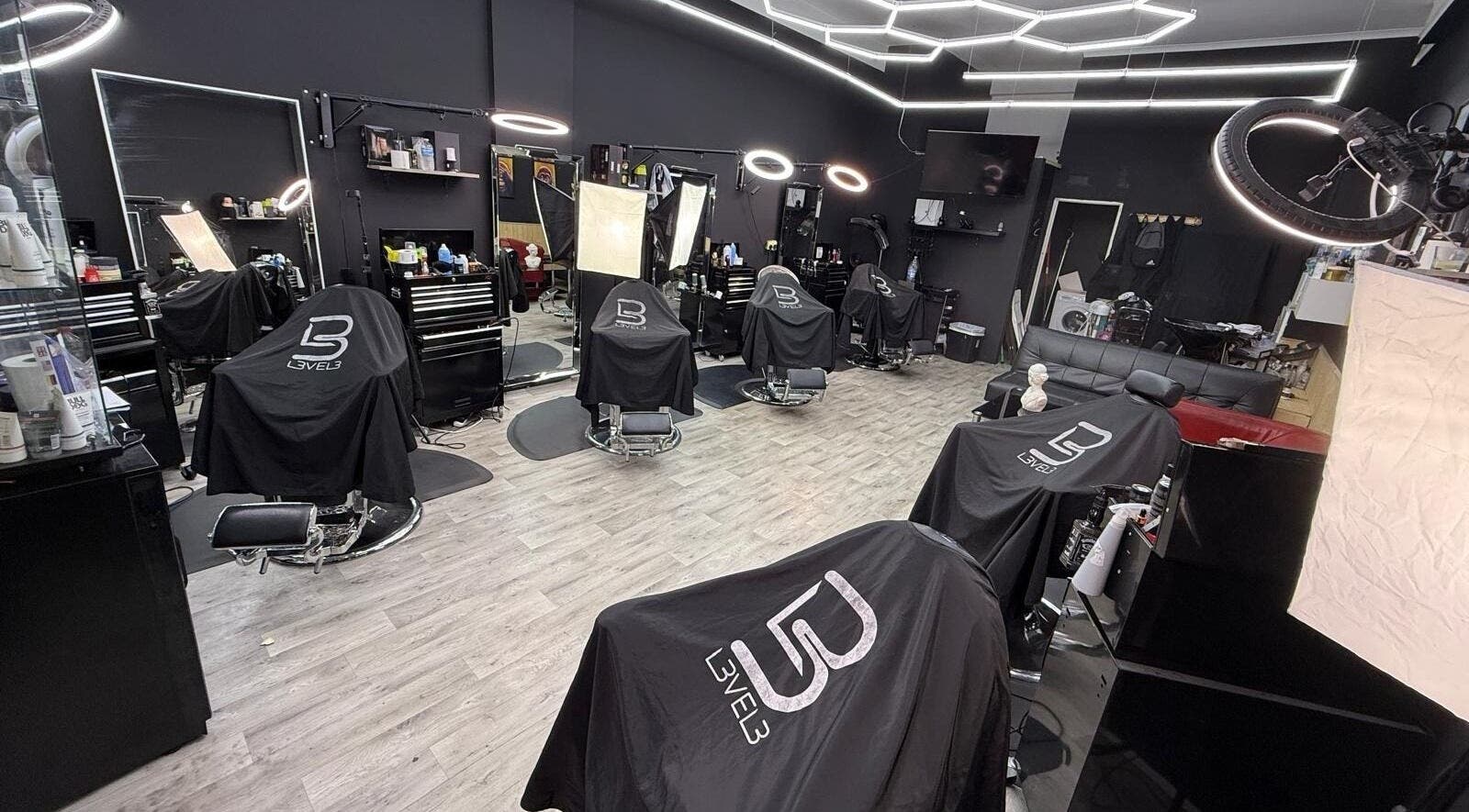 Modern interior of Cs Studio Vip Barbers in London, England, GB, featuring stylish barber chairs and lighting.