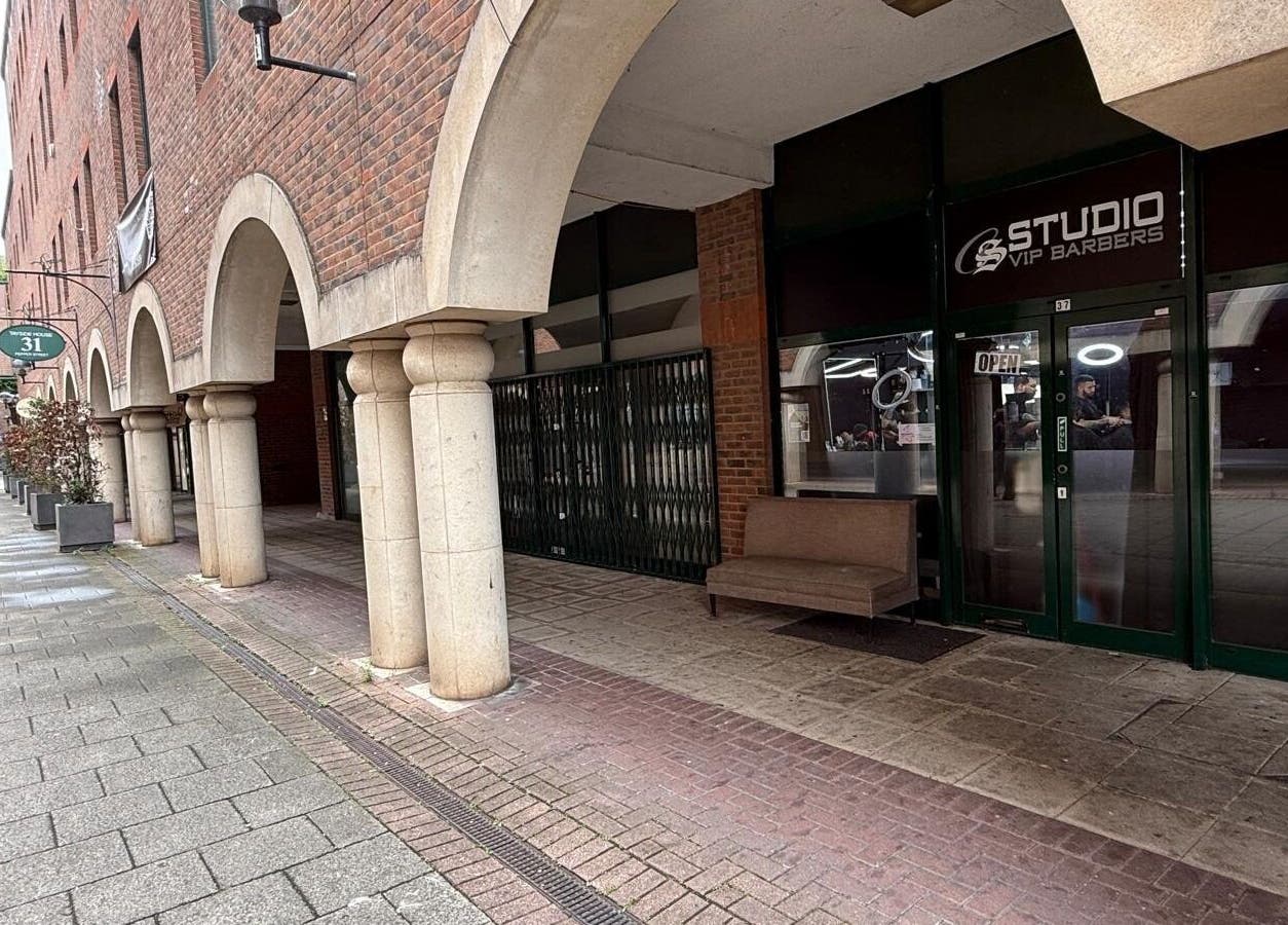 Entrance of Cs Studio Vip Barbers, located at a brick archway in London, England, GB.