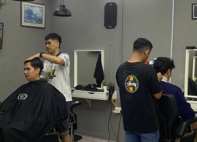 Stylists at work in Street Crew Barbershop, Kuala Lumpur, Wilayah Persekutuan Kuala Lumpur, MY, creating modern hairstyles.