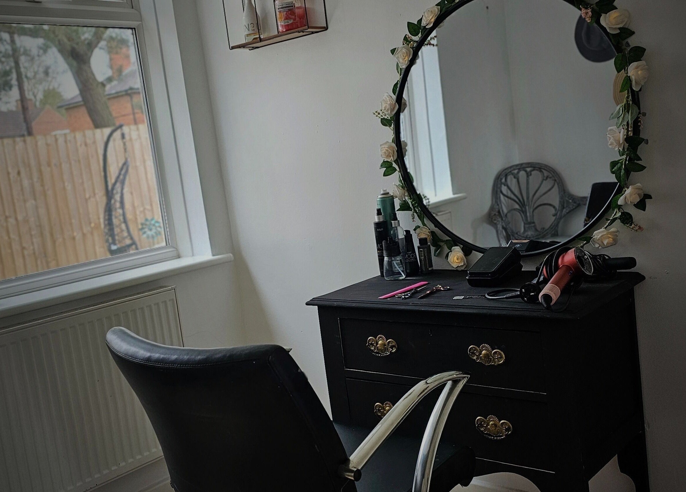 Elegant styling station at Taylor'd Hair in Catterick Garrison, England, GB, featuring a floral mirror and tools.