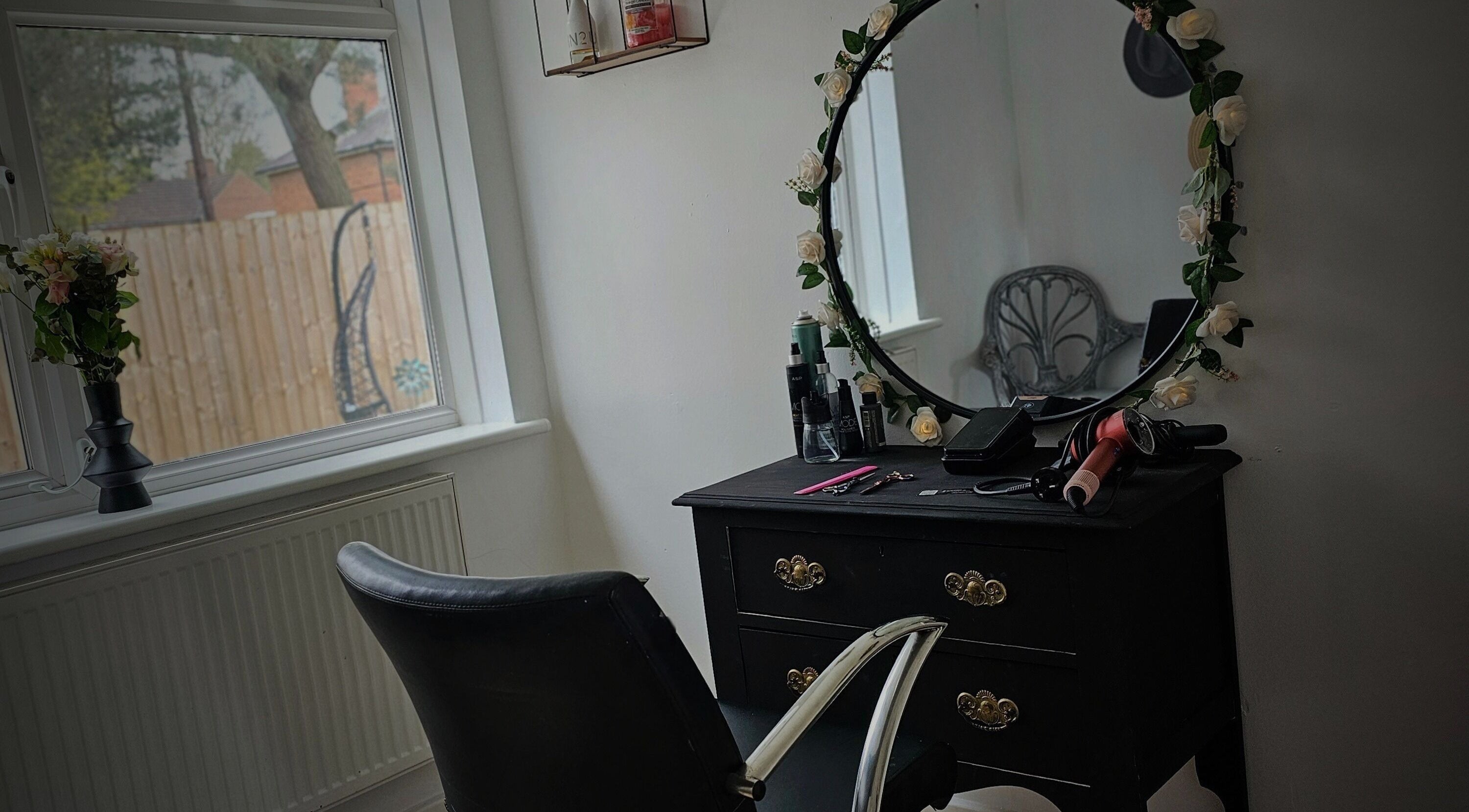 Elegant styling station at Taylor'd Hair in Catterick Garrison, England, GB, featuring a floral mirror and tools.