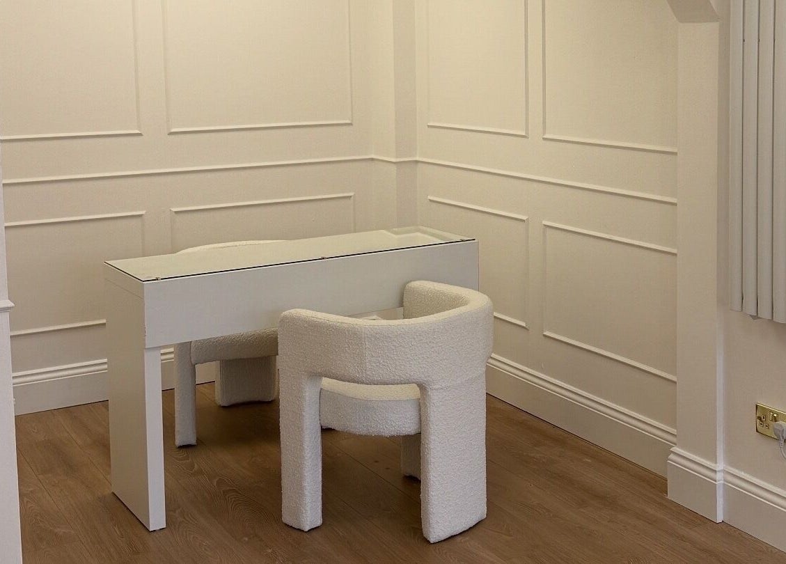 Elegant white desk and chair setup in Studio 22, Ripley, England, GB, offering a serene workspace.