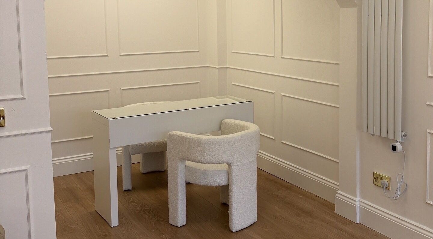 Elegant white desk and chair setup in Studio 22, Ripley, England, GB, offering a serene workspace.