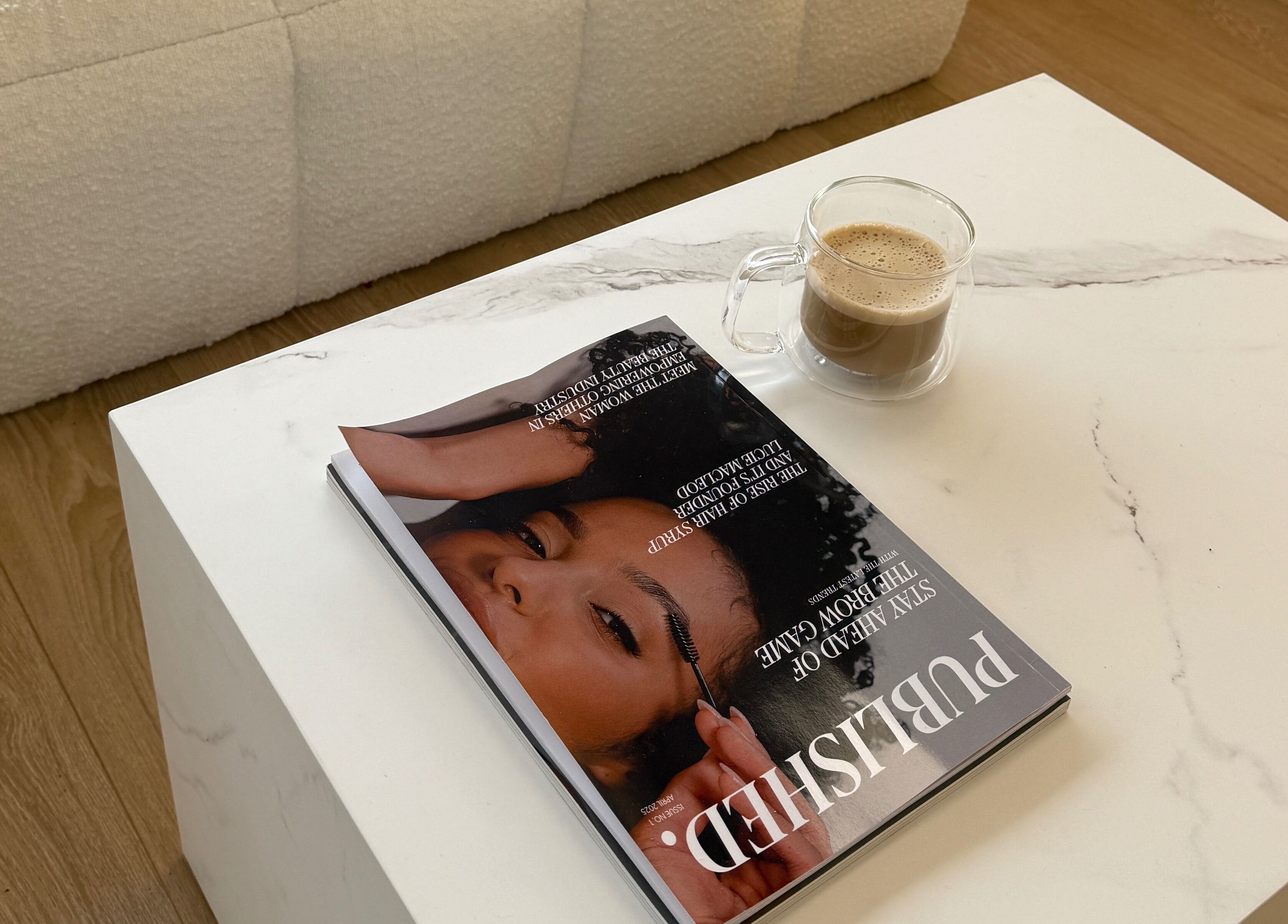 Cozy setup at Studio 22, Ripley, England, GB featuring a magazine and coffee on a white marble table.