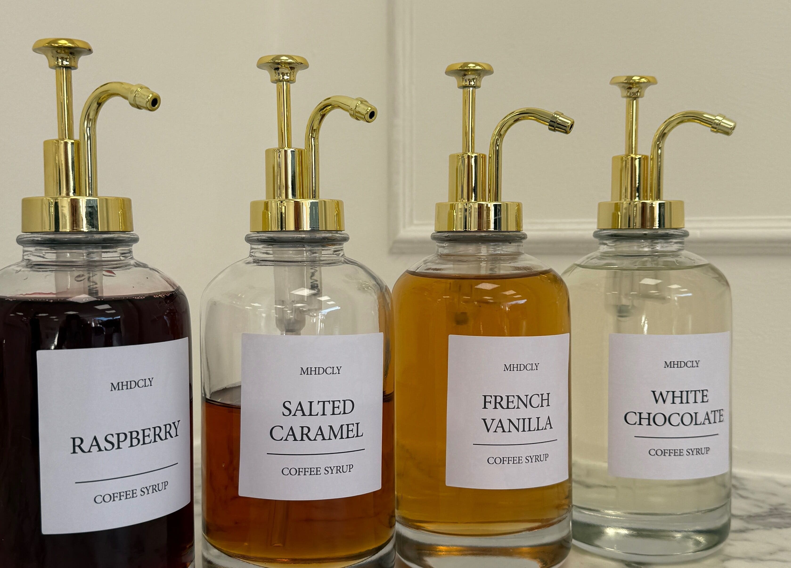 Elegant coffee syrup dispensers at Studio 22 in Ripley, England, GB.