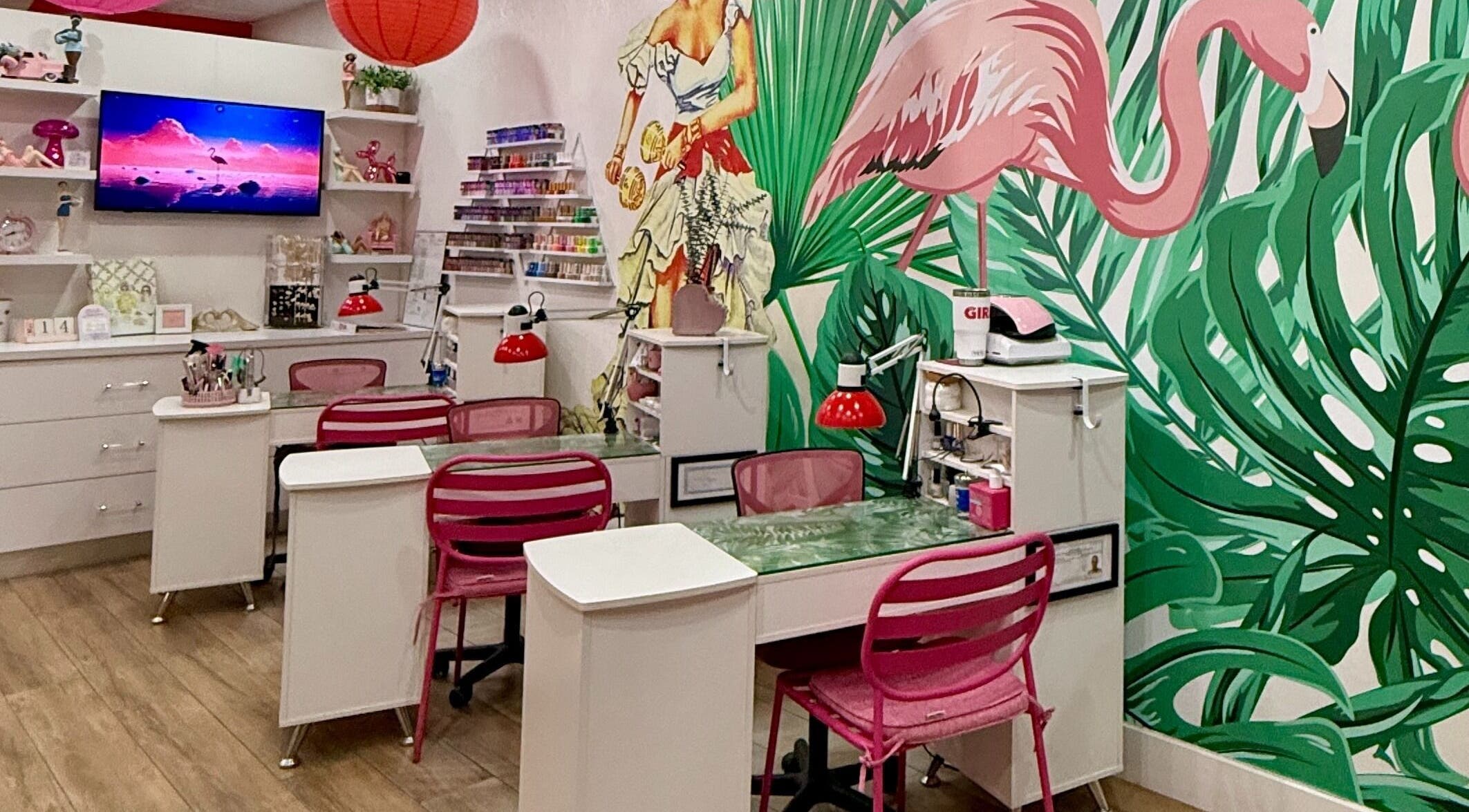 Vibrant nail salon at That Girl Beauty Bar, Miami, Florida, US, with tropical decor and pink chairs.