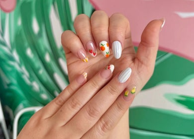 Vibrant fruit-themed nail art at That Girl Beauty Bar, Miami, Florida, US.