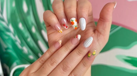 Vibrant fruit-themed nail art at That Girl Beauty Bar, Miami, Florida, US.