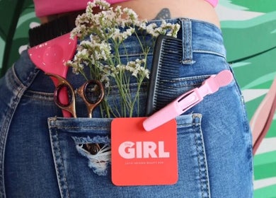 Stylish tools and blooms in jeans pocket at That Girl Beauty Bar, Miami, Florida, US.