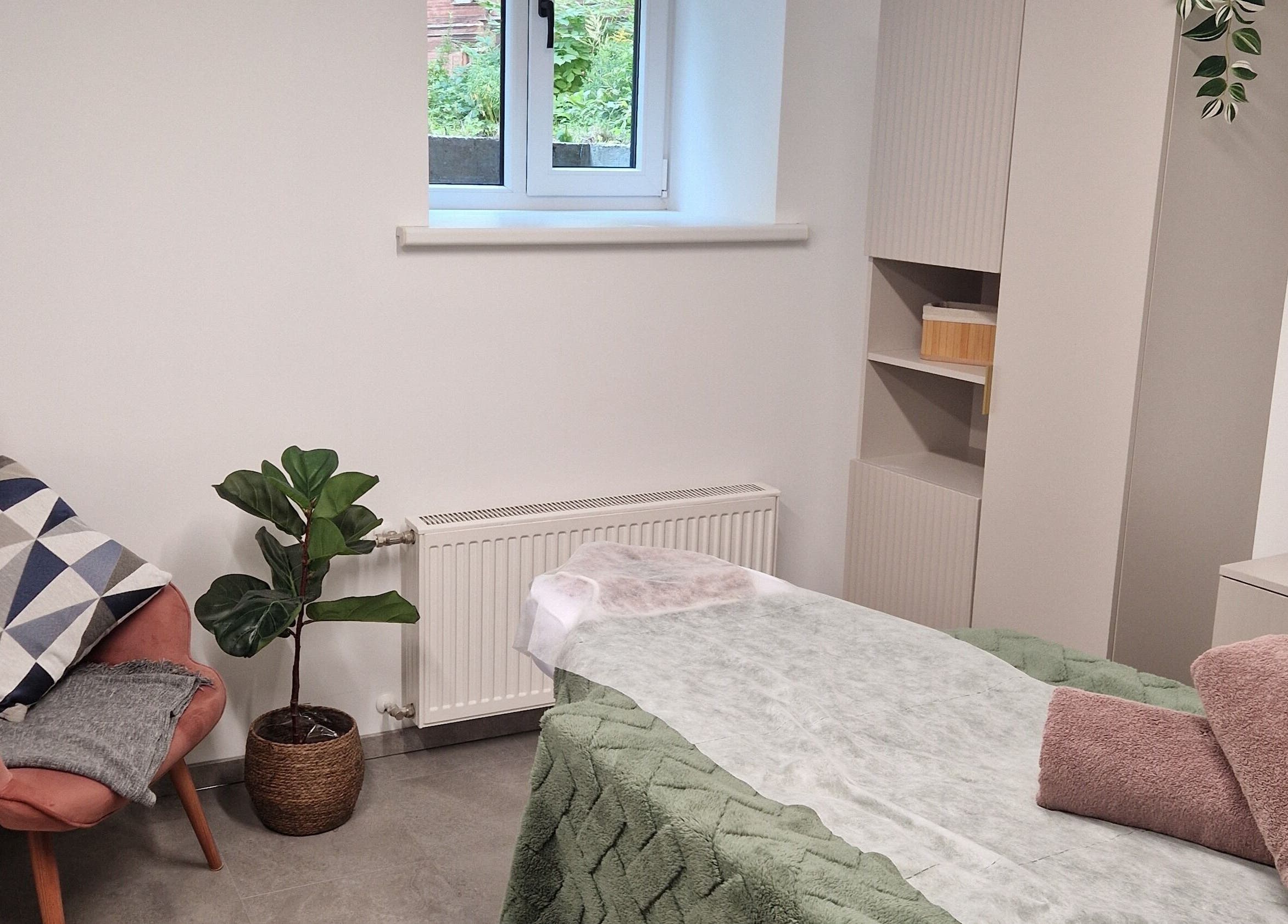 Serene treatment room at Ķermeņa procedūras Pārdaugavā, Rīga, LV with a plush chair and massage table.