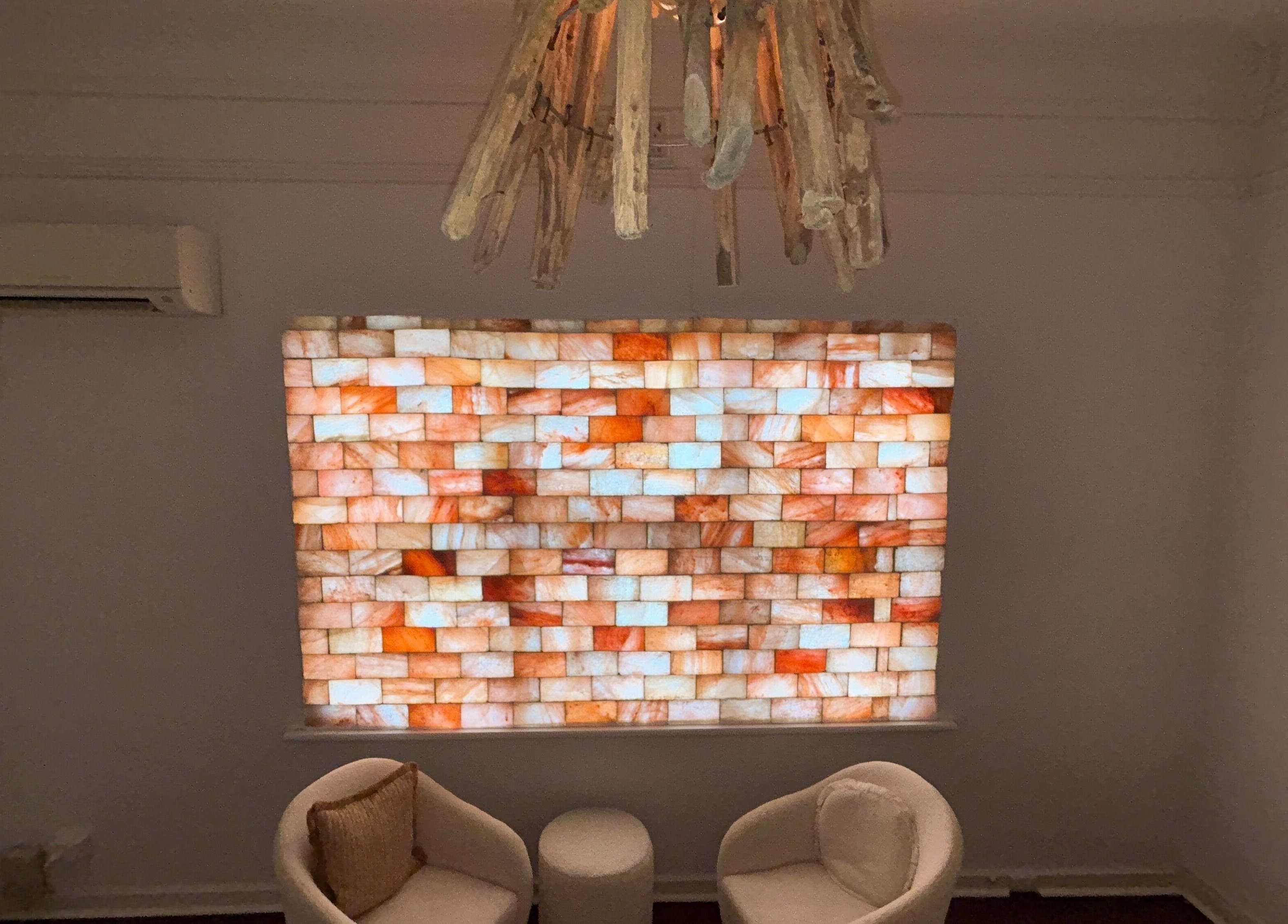 Cozy lounge with glowing salt wall at Palm Beach Wellness Nedlands, Nedlands, Western Australia, AU.