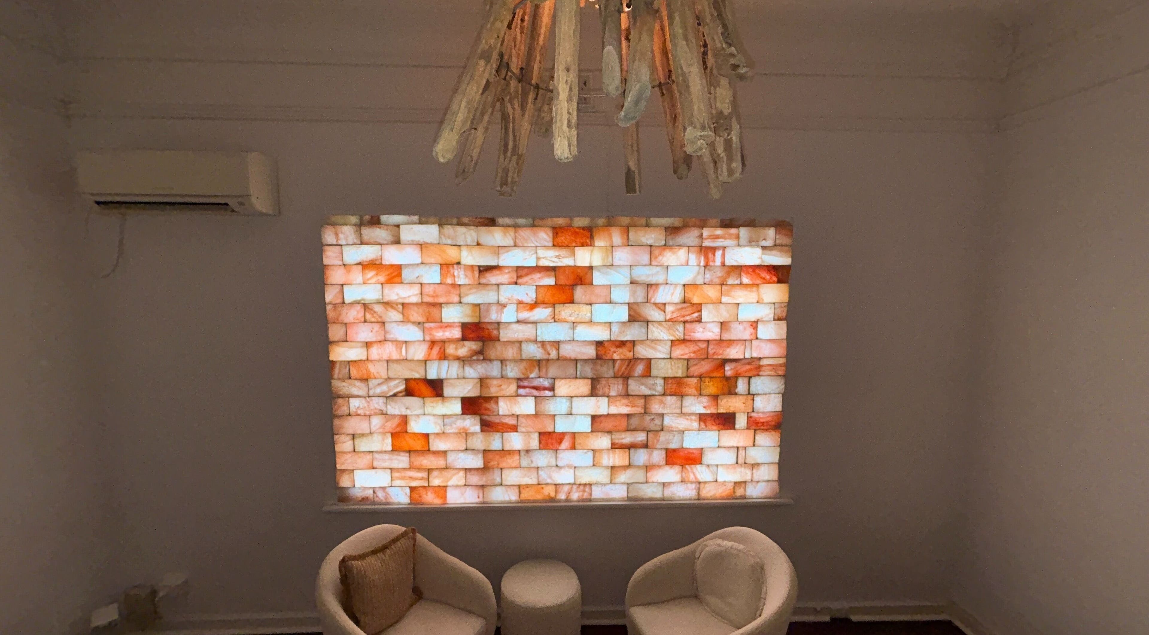 Cozy lounge with glowing salt wall at Palm Beach Wellness Nedlands, Nedlands, Western Australia, AU.