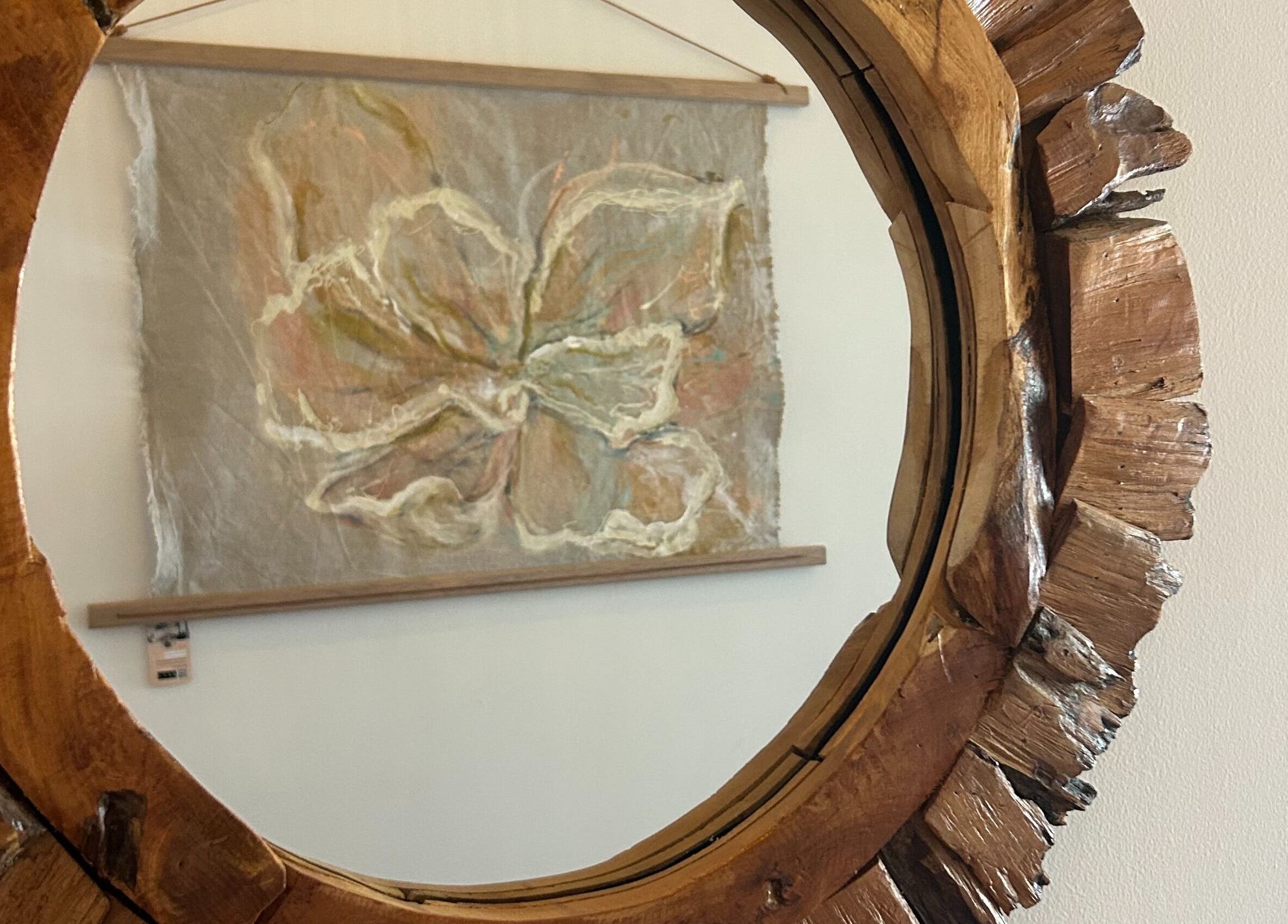 Rustic wooden mirror reflecting abstract art at Palm Beach Wellness Nedlands, Nedlands, Western Australia, AU.