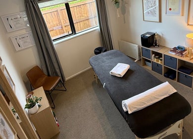 Relaxing therapy room at Recover Well Massage Therapy, Rolleston, Canterbury, NZ with massage table and decor.
