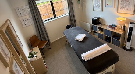 Relaxing therapy room at Recover Well Massage Therapy, Rolleston, Canterbury, NZ with massage table and decor.