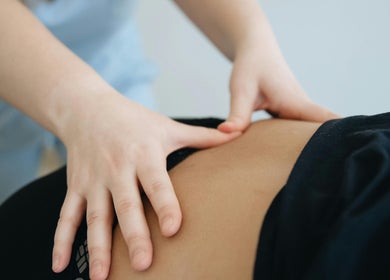 Therapist provides back massage at Recover Well Massage Therapy, Rolleston, Canterbury, NZ.
