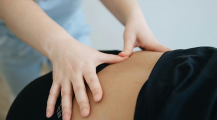 Therapist provides back massage at Recover Well Massage Therapy, Rolleston, Canterbury, NZ.