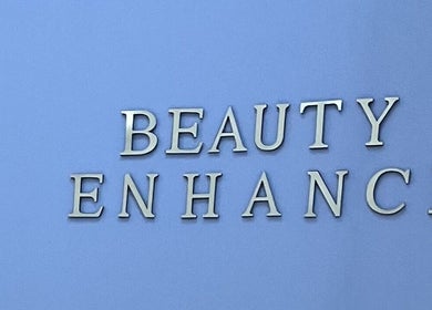 Beauty Enhance Limited sign at Cardiff, Wales, GB. Modern lettering on a sleek blue backdrop.