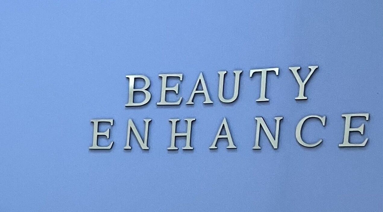 Beauty Enhance Limited sign at Cardiff, Wales, GB. Modern lettering on a sleek blue backdrop.