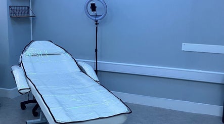 Relaxing treatment room at Beauty Enhance Limited, Cardiff, Wales, GB with a comfortable bed and modern lighting.