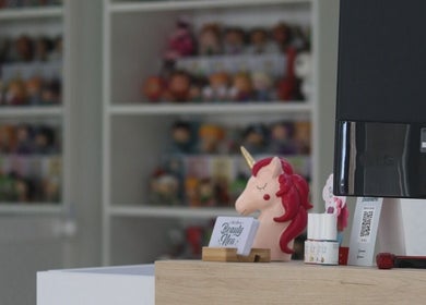 Figura de unicornio y tarjeta de Beauty Neu en una mesa en Córdoba, Andalucía, ES.