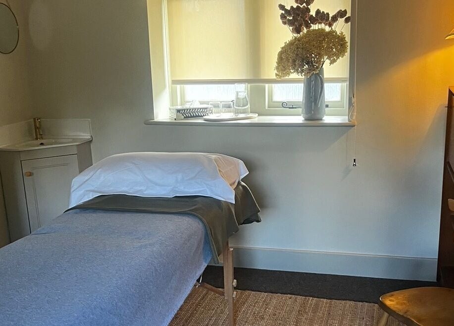 Cozy therapy room at Slow it down holistic therapies, Petworth, England, GB, with a massage bed and soothing decor.