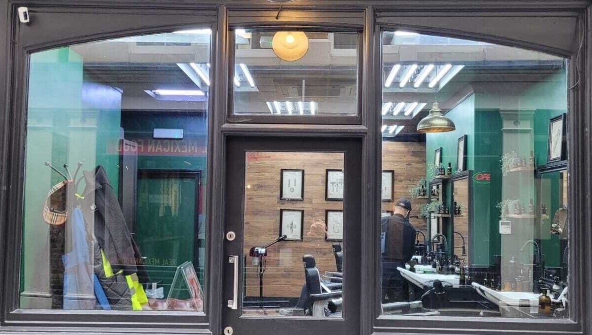 Front view of Mane Man Grooming Ltd in London, England, GB showcasing stylish interior with barber chairs and decor.