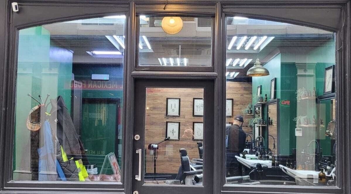 Front view of Mane Man Grooming Ltd in London, England, GB showcasing stylish interior with barber chairs and decor.