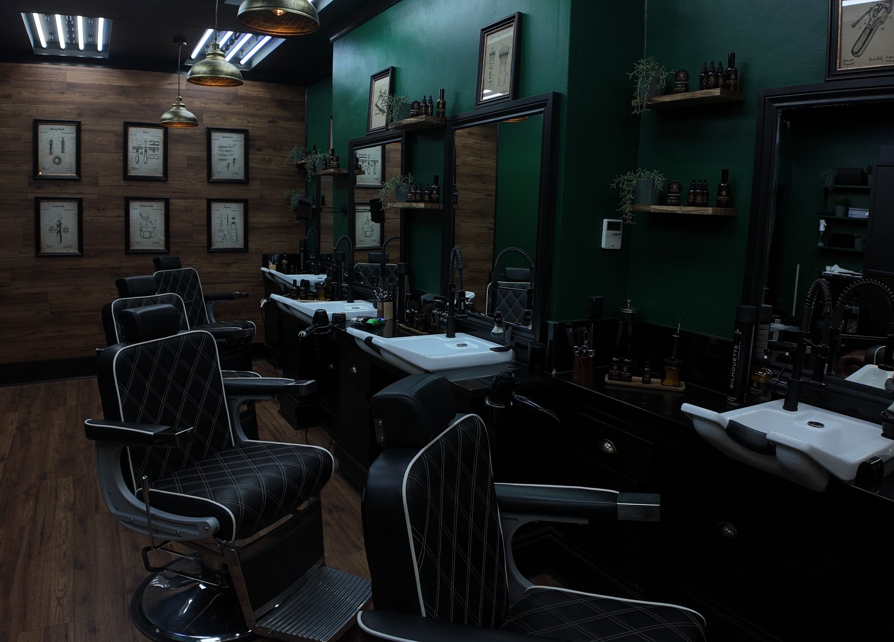 Elegant interior of Mane Man Grooming Ltd in London, England, GB with sleek barber chairs and wooden decor.