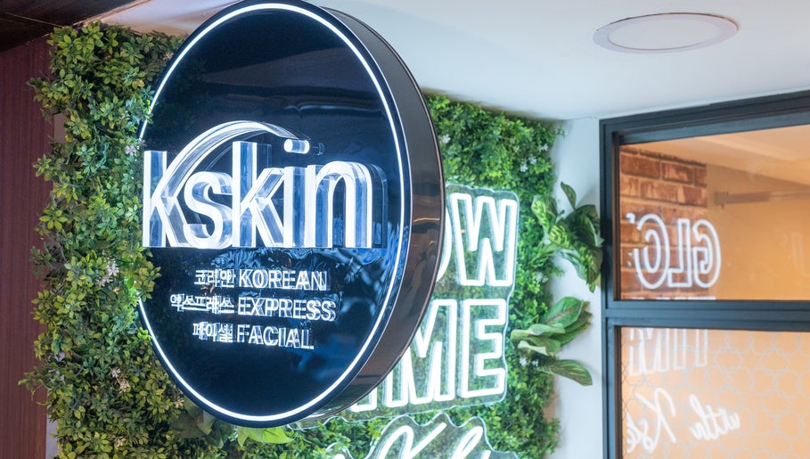 Kskin Korean Express Facial signage at Chinatown Point, Singapore, SG, surrounded by lush greenery decor.