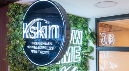 Kskin Korean Express Facial signage at Chinatown Point, Singapore, SG, surrounded by lush greenery decor.