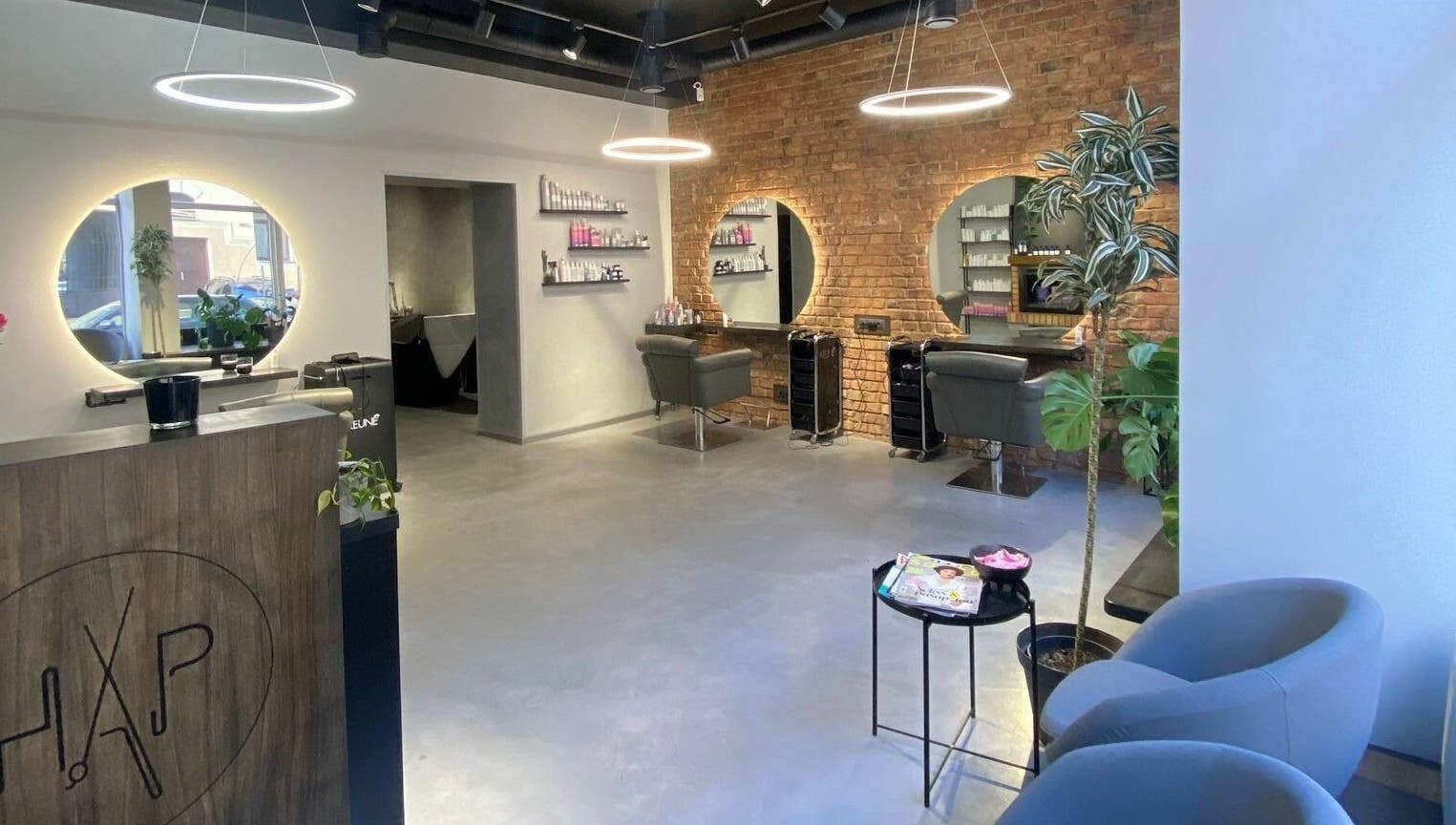 Modern interior of Hairport Studija in Rīga, LV with sleek design and inviting seating.