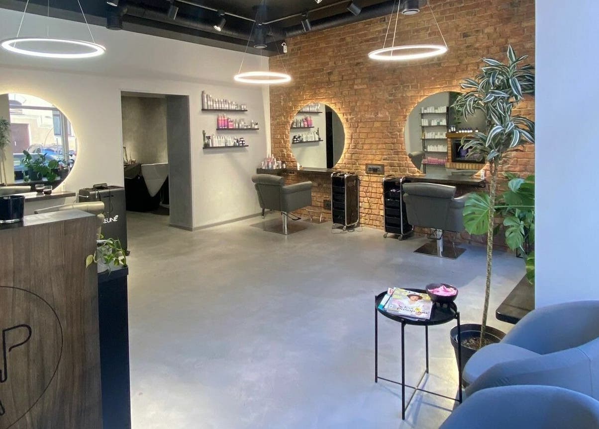 Modern interior of Hairport Studija in Rīga, LV with sleek design and inviting seating.