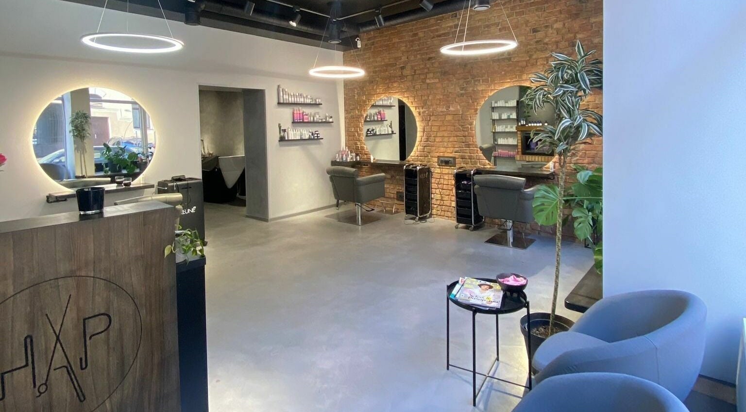 Modern interior of Hairport Studija in Rīga, LV with sleek design and inviting seating.