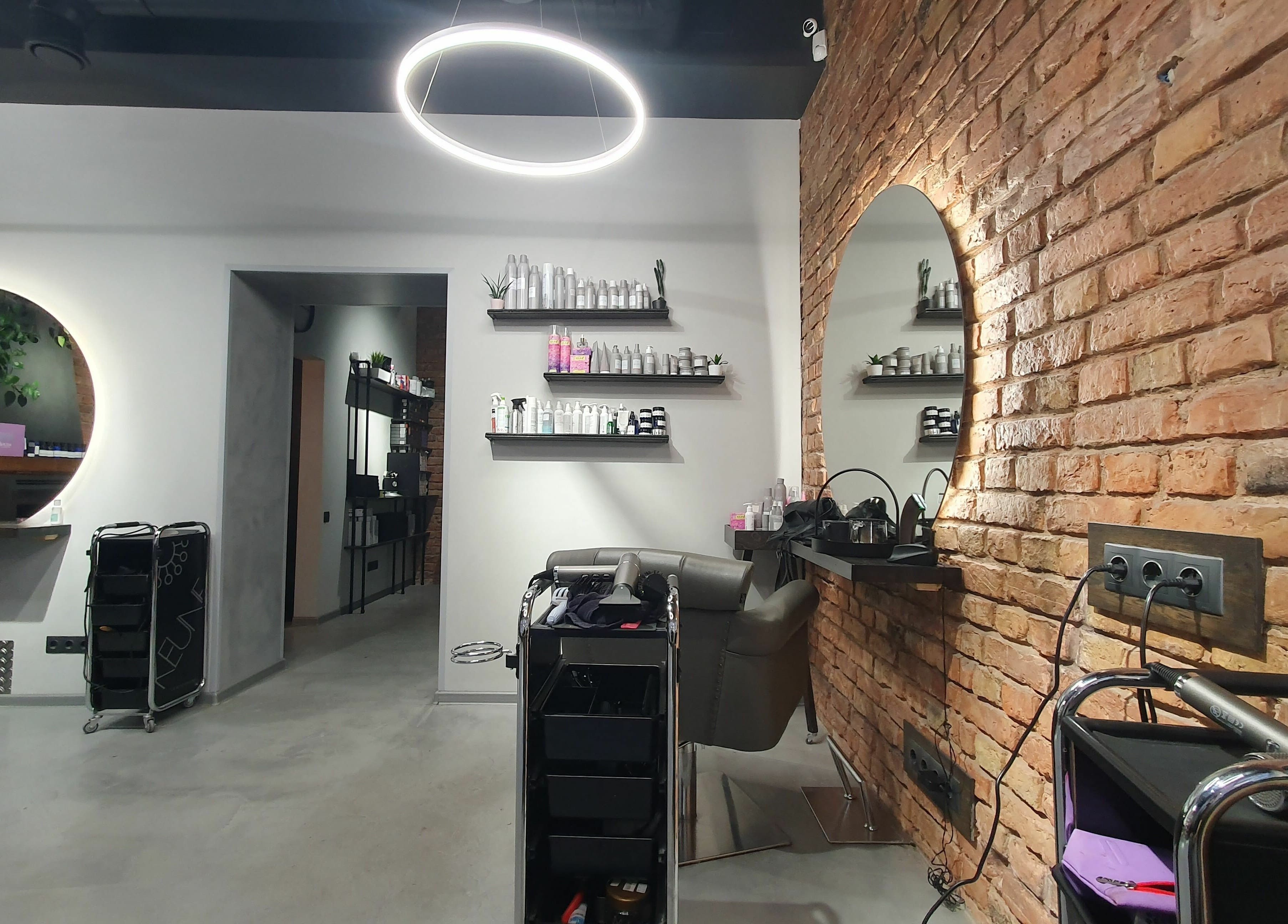 Modern interior of Hairport Studija in Rīga, LV, featuring stylish mirrors and salon equipment.