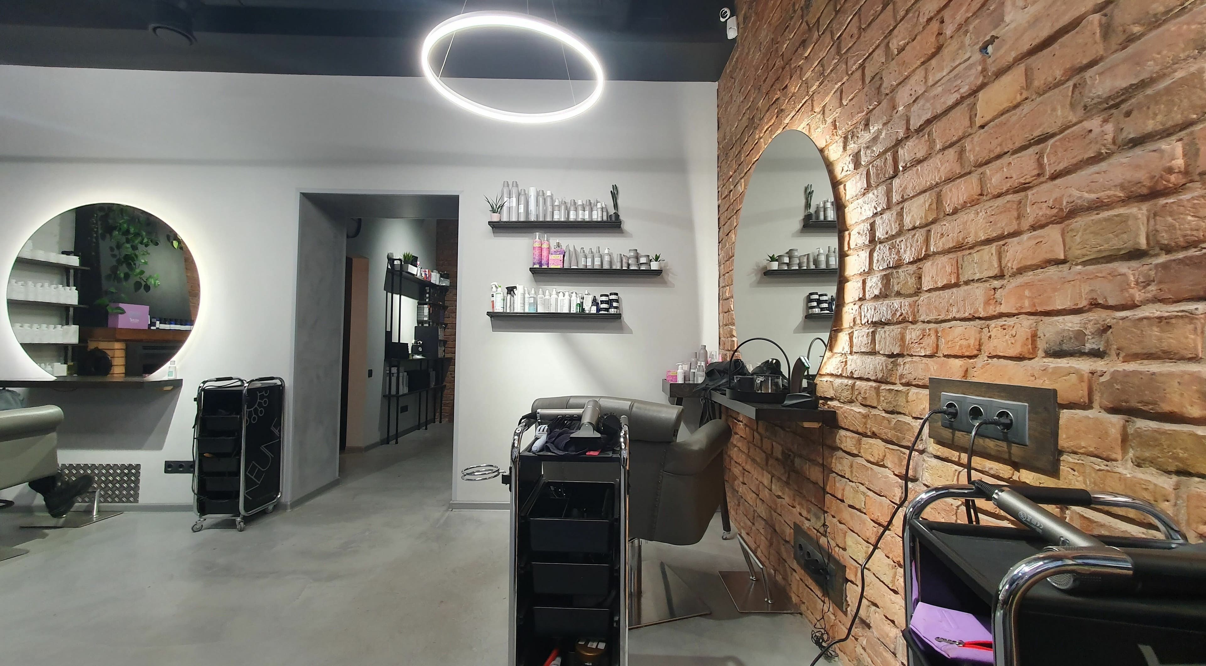 Modern interior of Hairport Studija in Rīga, LV, featuring stylish mirrors and salon equipment.
