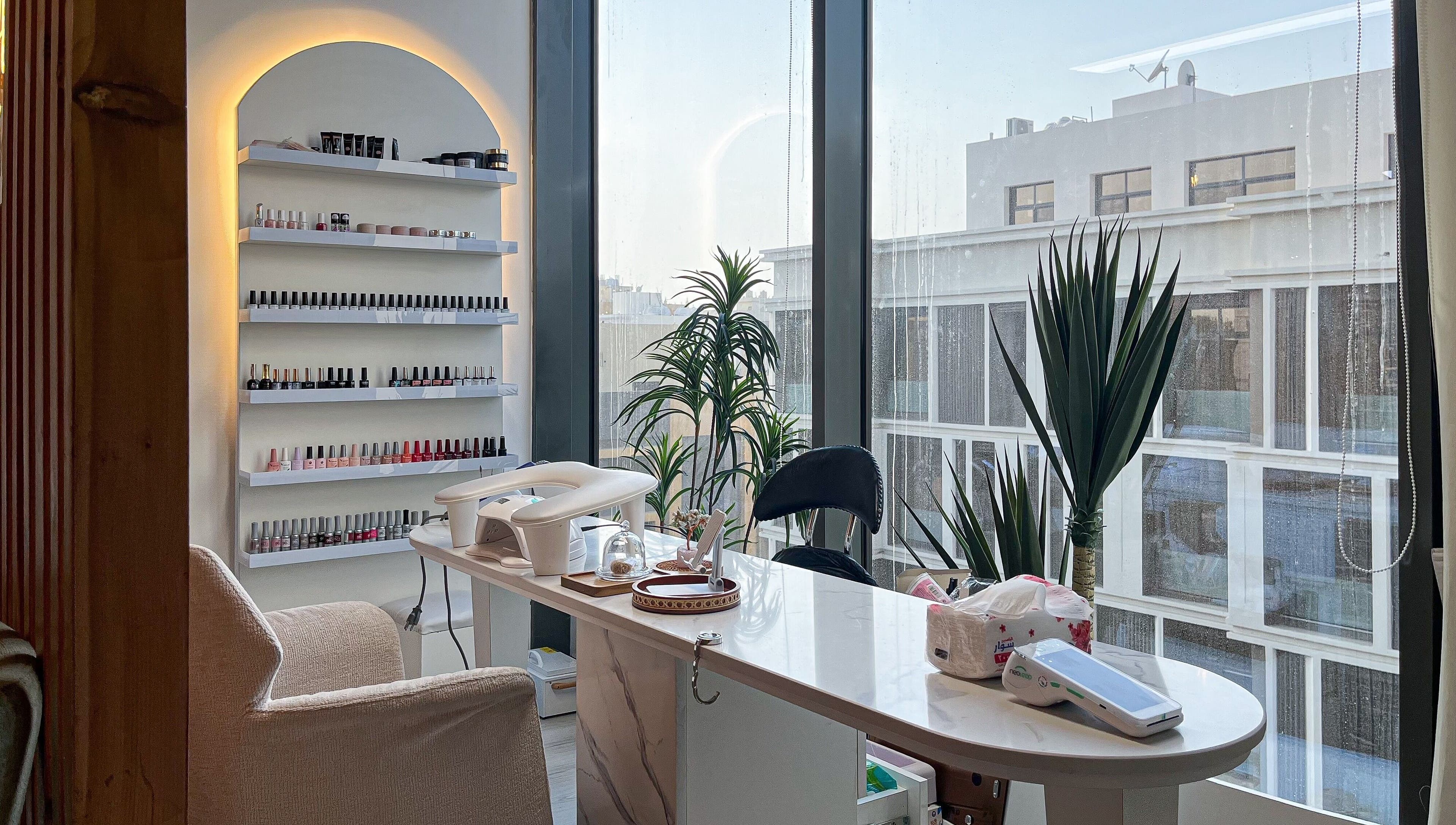 Mona Beauty's serene nail studio in Jeddah, Makkah Province, SA with modern decor and city views.