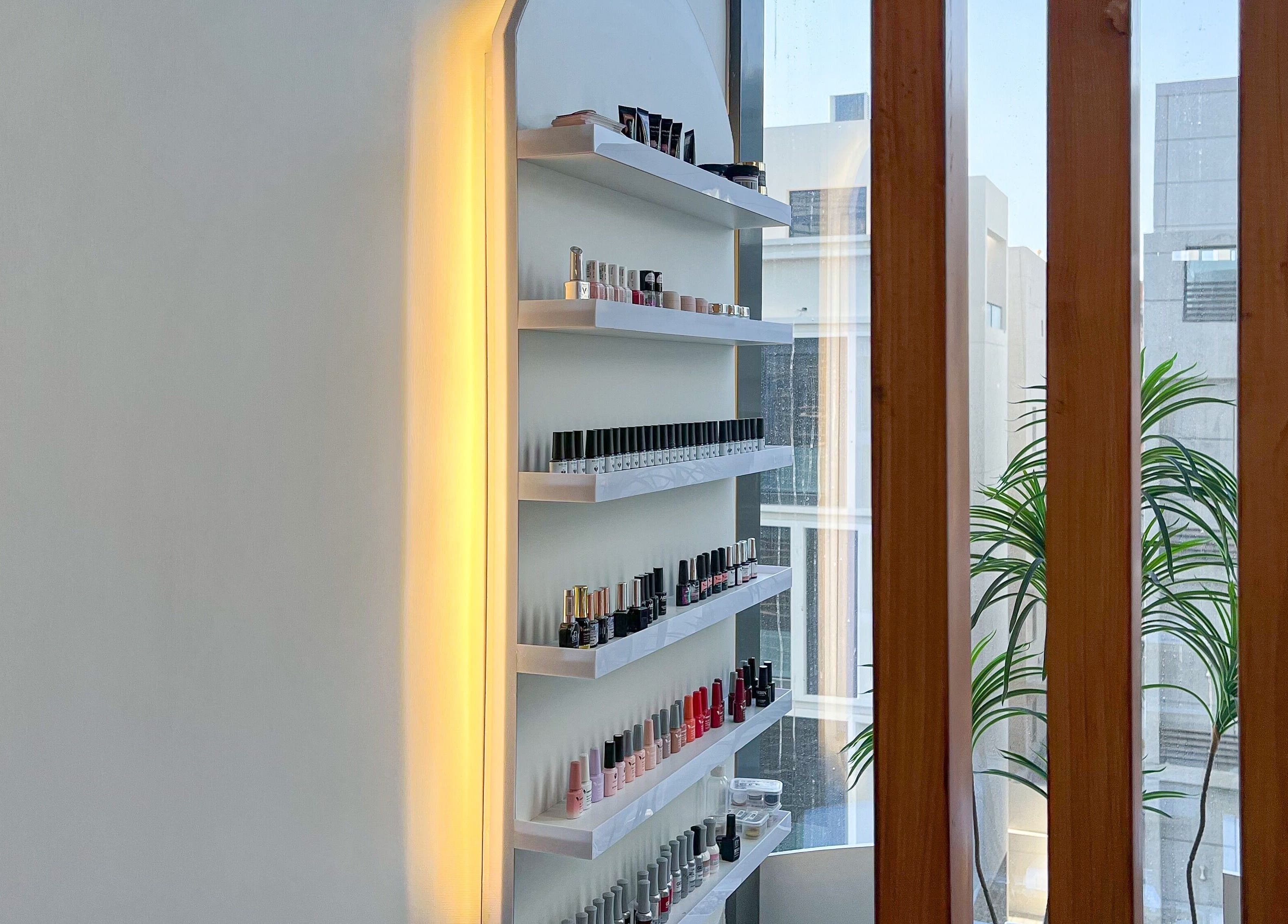 Nail polish display at Mona Beauty in Jeddah, Makkah Province, SA, showcasing a variety of colors.