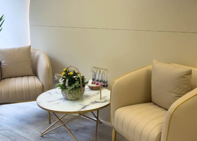 Elegant seating area at Glow Beauty Studio, Guernsey, Saint Peter Port, GG, with comfy chairs and a marble table.