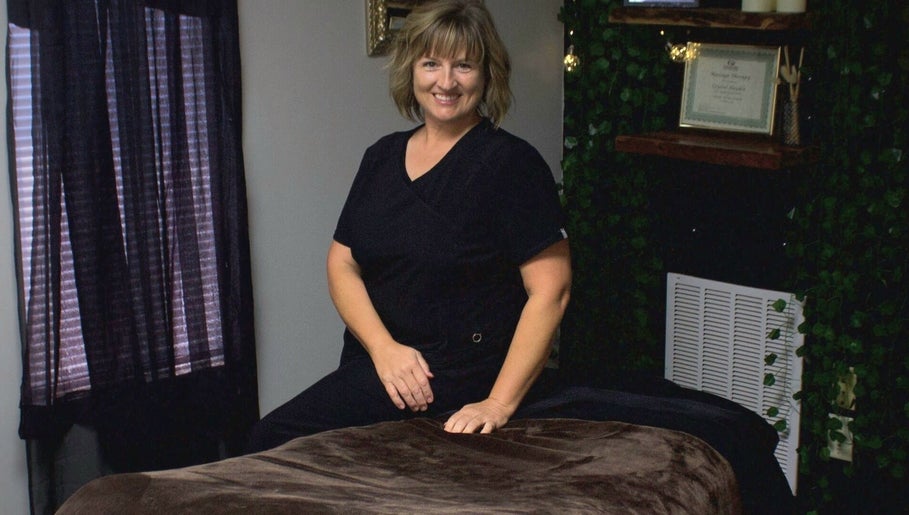 Crystal Hayden LMT at relaxing massage room in Greer, South Carolina, US, ready to provide a serene experience.