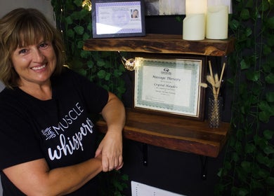 Crystal Hayden LMT stands beside massage therapy certification, Greer, South Carolina, US.