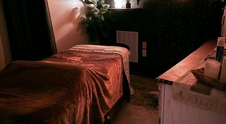 Relaxing massage room at Crystal Hayden LMT in Greer, South Carolina, US with soft lighting and plush bedding.