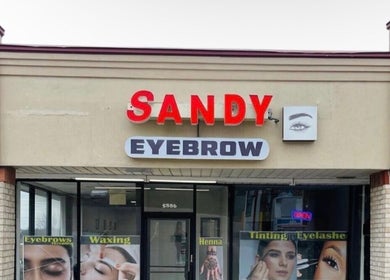 Front view of Sandy Eyebrows in Cincinnati, Ohio, US, showcasing service posters and building entrance.