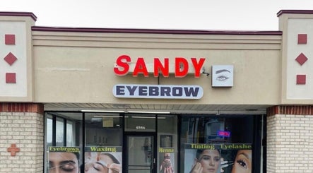 Front view of Sandy Eyebrows in Cincinnati, Ohio, US, showcasing service posters and building entrance.