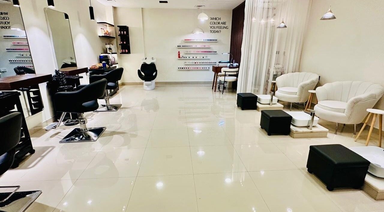 Chic interior of Braid Beauty Center's salon in Sharjah, Sharjah, AE, featuring modern styling chairs and nail stations.