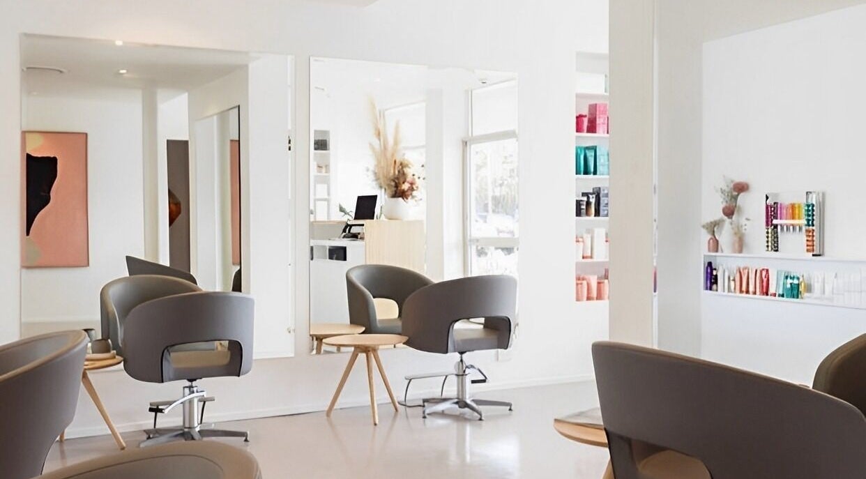 Modern interior of Joia Hair Studio - Lennox Head, stylish chairs and product shelves, Lennox Head, NSW, AU.