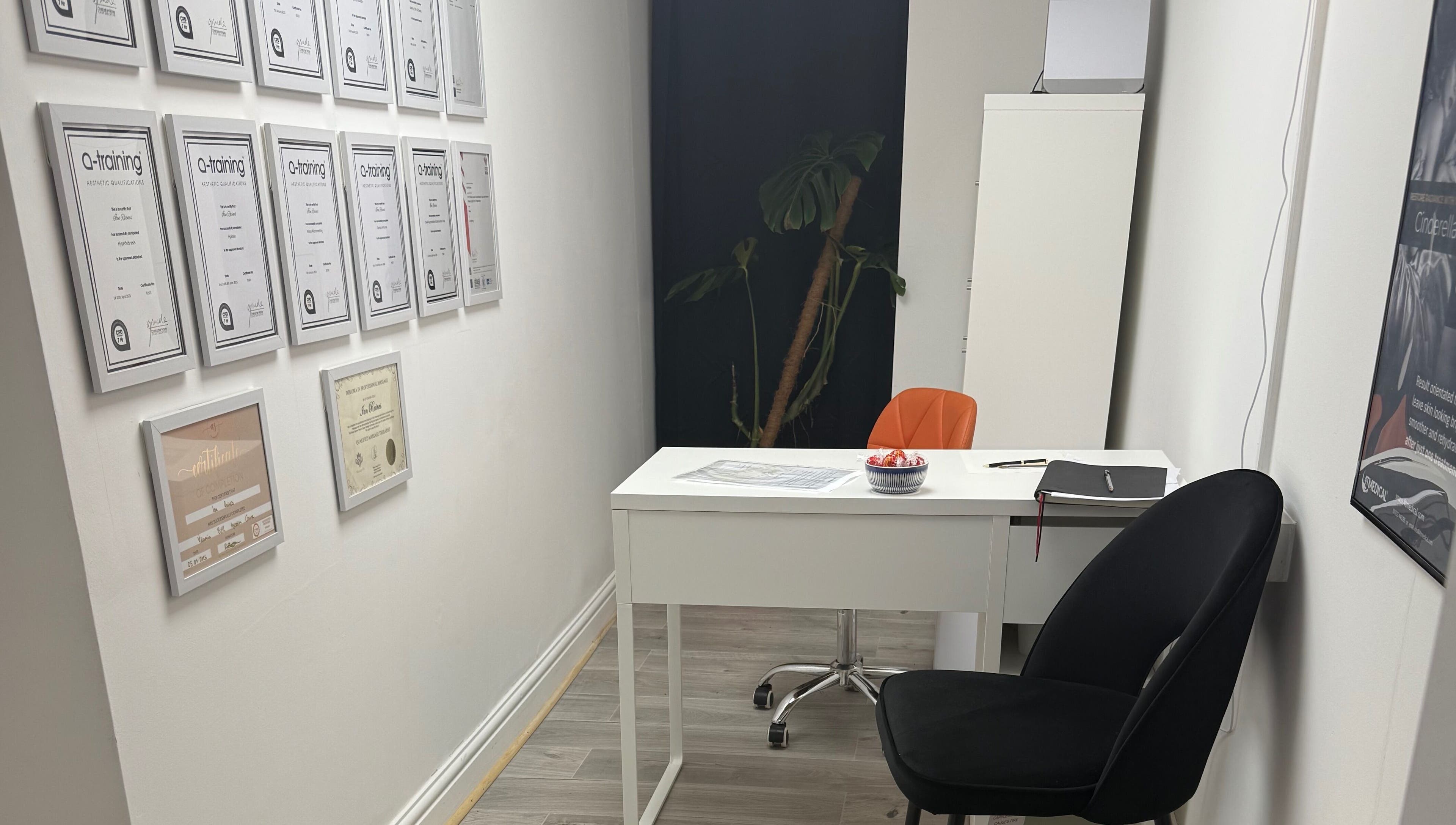 Modern consulting room at Refresh by Ian in Sutton On Sea, England, GB with certificate wall display.