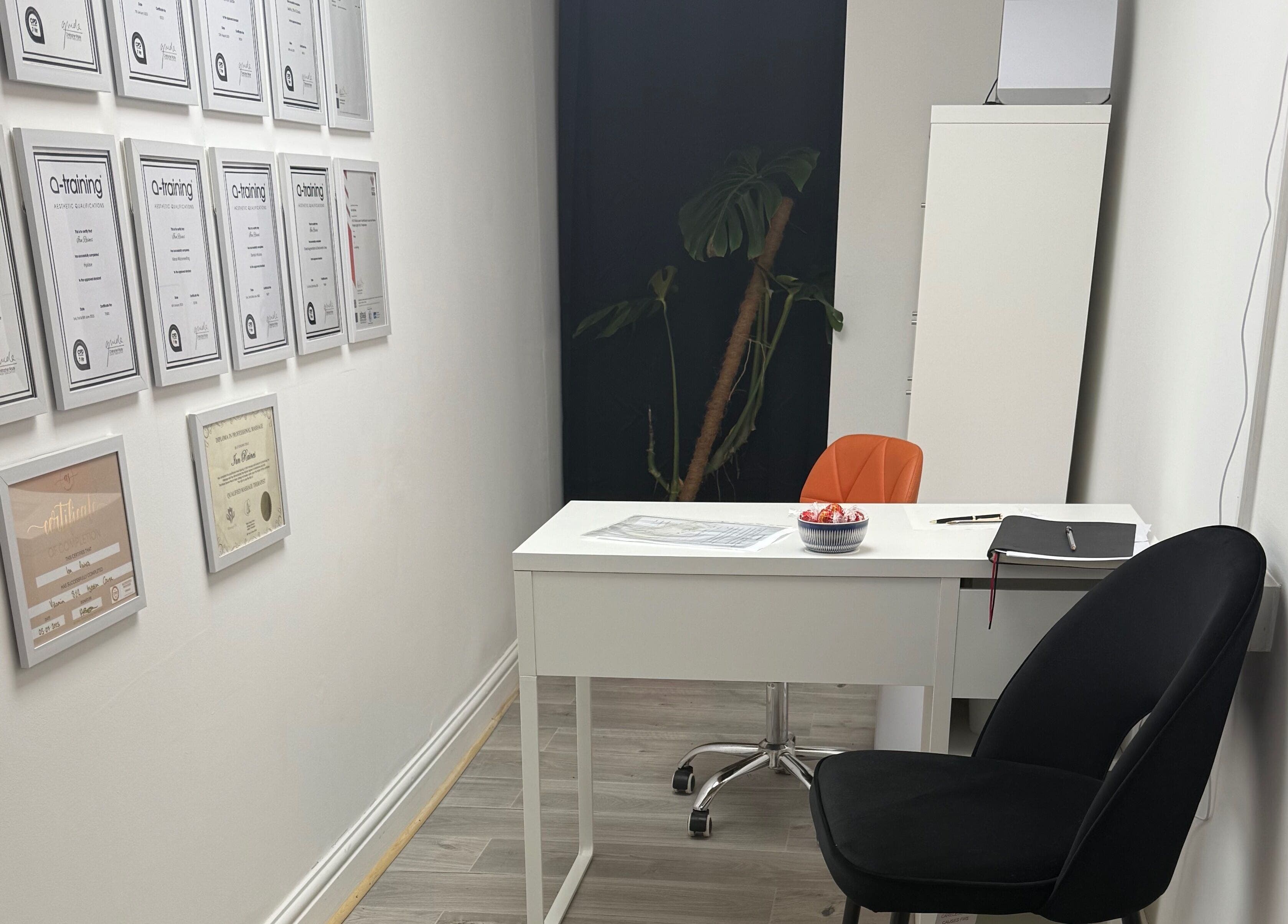 Modern consulting room at Refresh by Ian in Sutton On Sea, England, GB with certificate wall display.