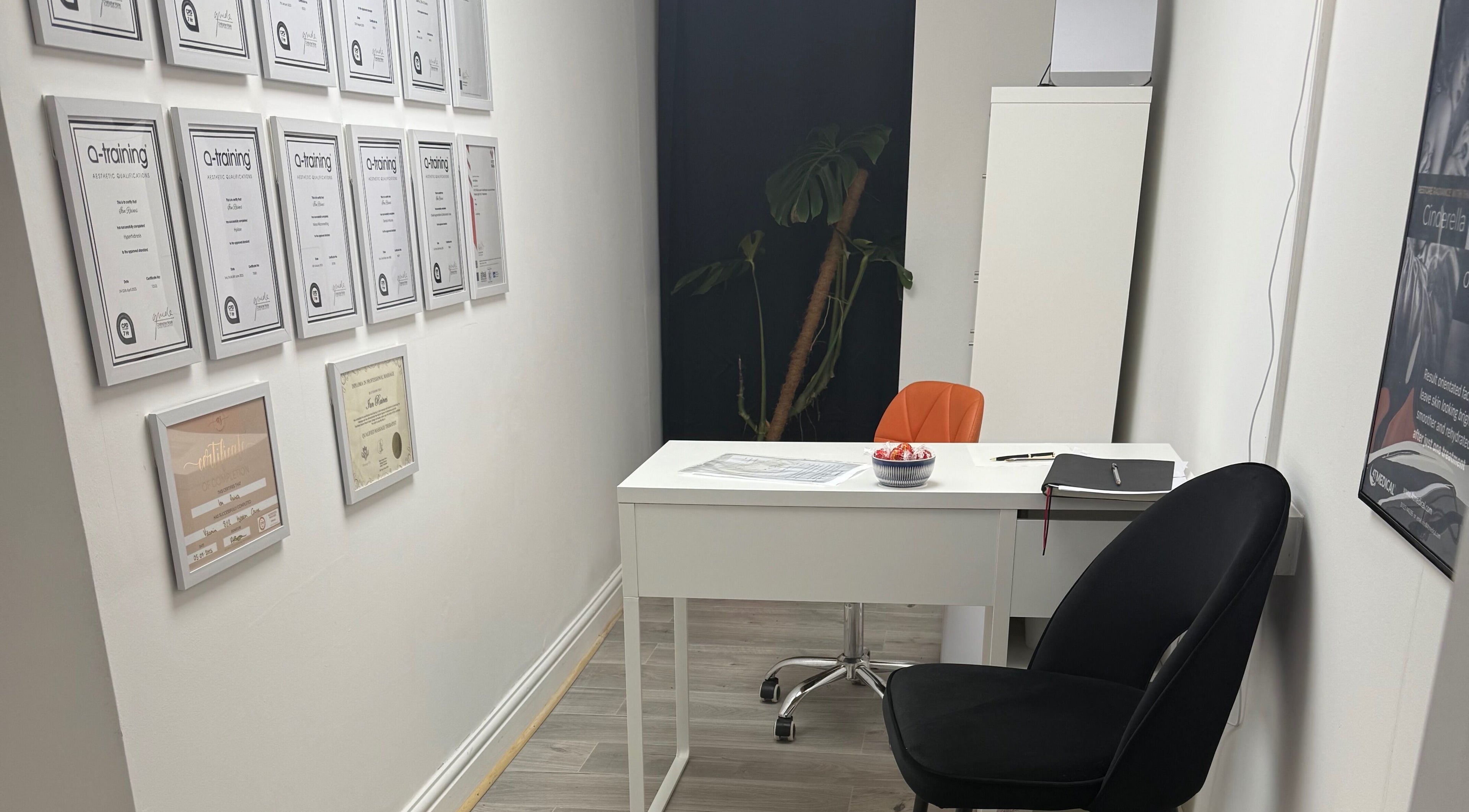 Modern consulting room at Refresh by Ian in Sutton On Sea, England, GB with certificate wall display.